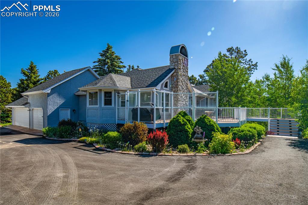 17815 Saddlewood Road Monument, CO 80132 - Photo 5 of 40 a front view of a house with garden