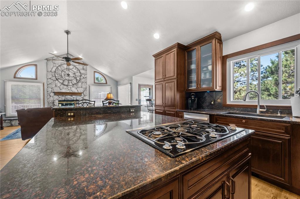 17815 Saddlewood Road Monument, CO 80132 - Photo 9 of 40 a kitchen with a stove a sink and a wooden cabinets