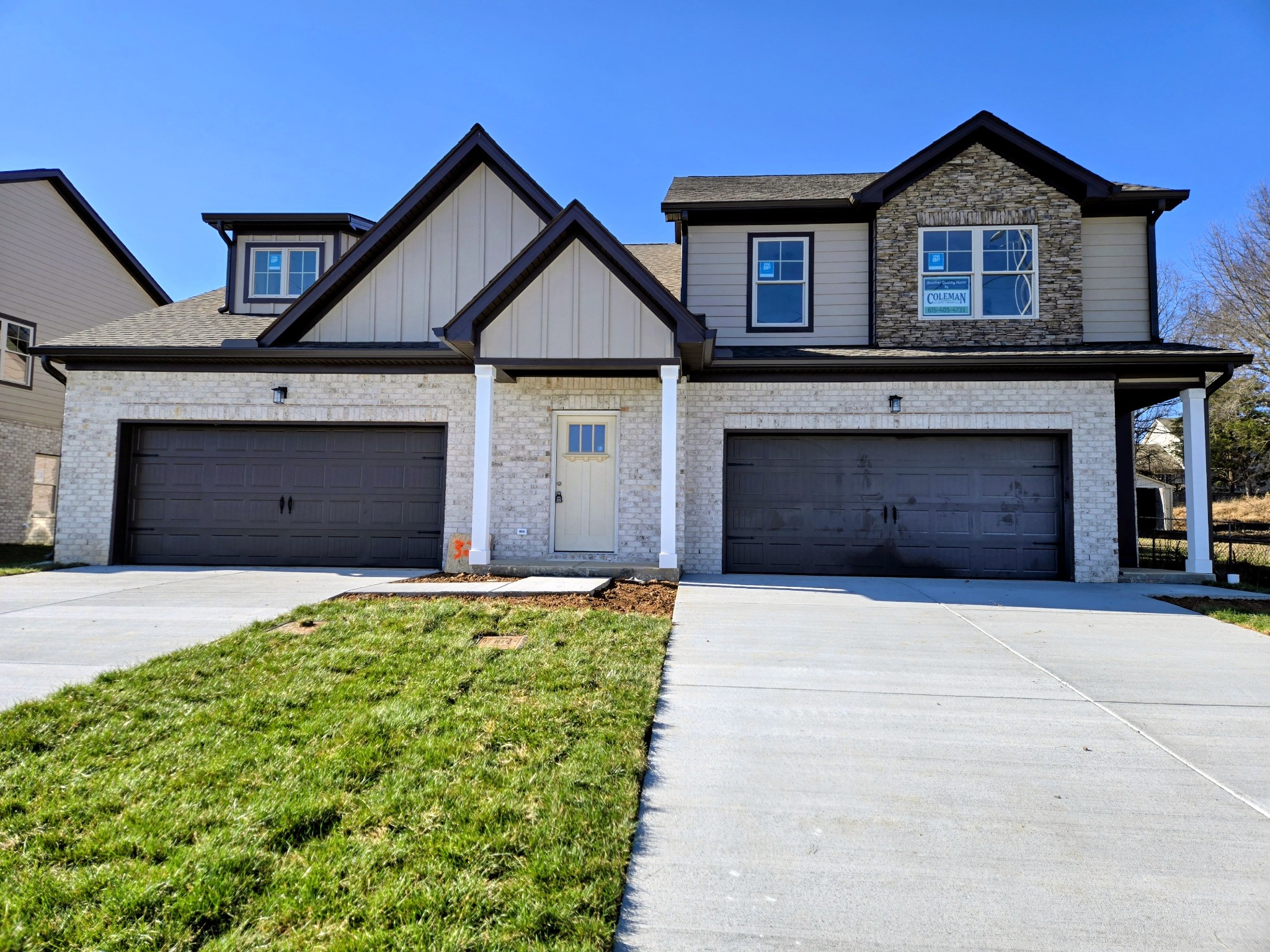 324 Chaney Road, Unit 5 Smyrna, TN 37167 - Photo 2 of 19 a front view of a house with a yard and garage