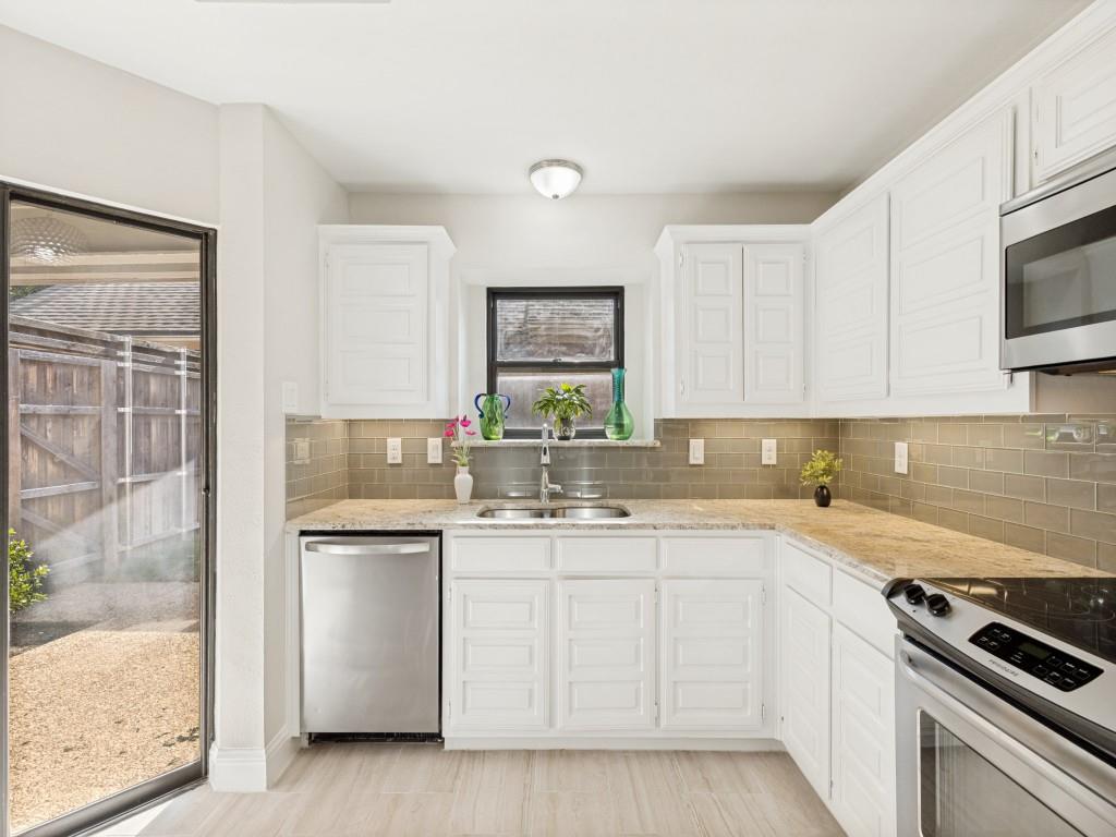 4010 Rive Lane Addison, TX 75001 - Photo 10 of 25 a kitchen with white cabinets and white appliances
