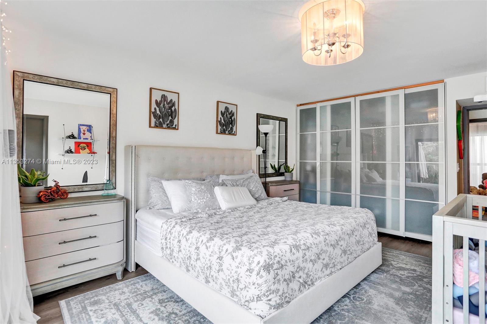 1037 Northeast 202nd Lane Miami, FL 33179 - Photo 11 of 21 a bedroom with a bed painting on wall and a window