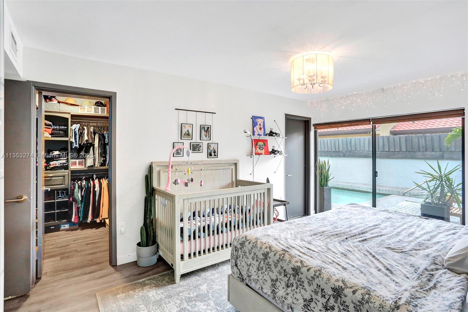 1037 Northeast 202nd Lane Miami, FL 33179 - Photo 12 of 21 a bedroom with a bed and a window