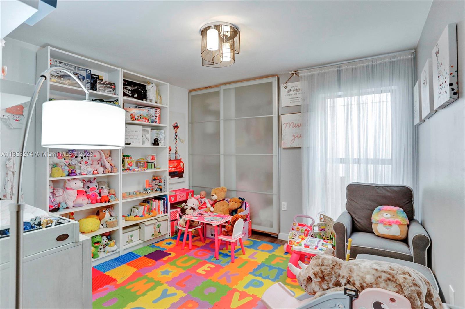 1037 Northeast 202nd Lane Miami, FL 33179 - Photo 15 of 21 a bedroom with baby toys and a couch