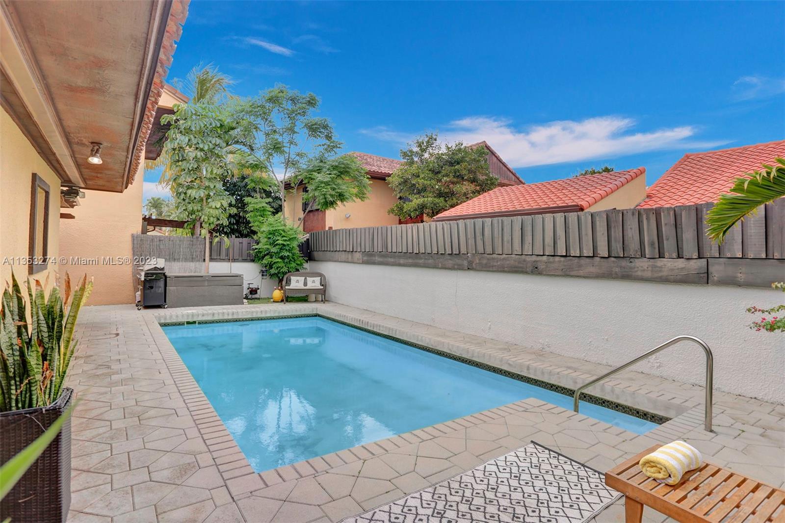 1037 Northeast 202nd Lane Miami, FL 33179 - Photo 19 of 21 a balcony with potted plants and a table
