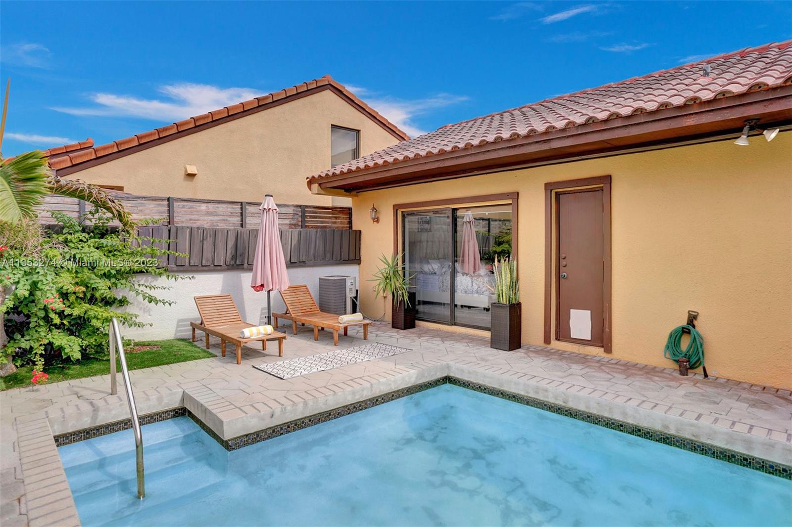 1037 Northeast 202nd Lane Miami, FL 33179 - Photo 20 of 21 a view of a house with patio