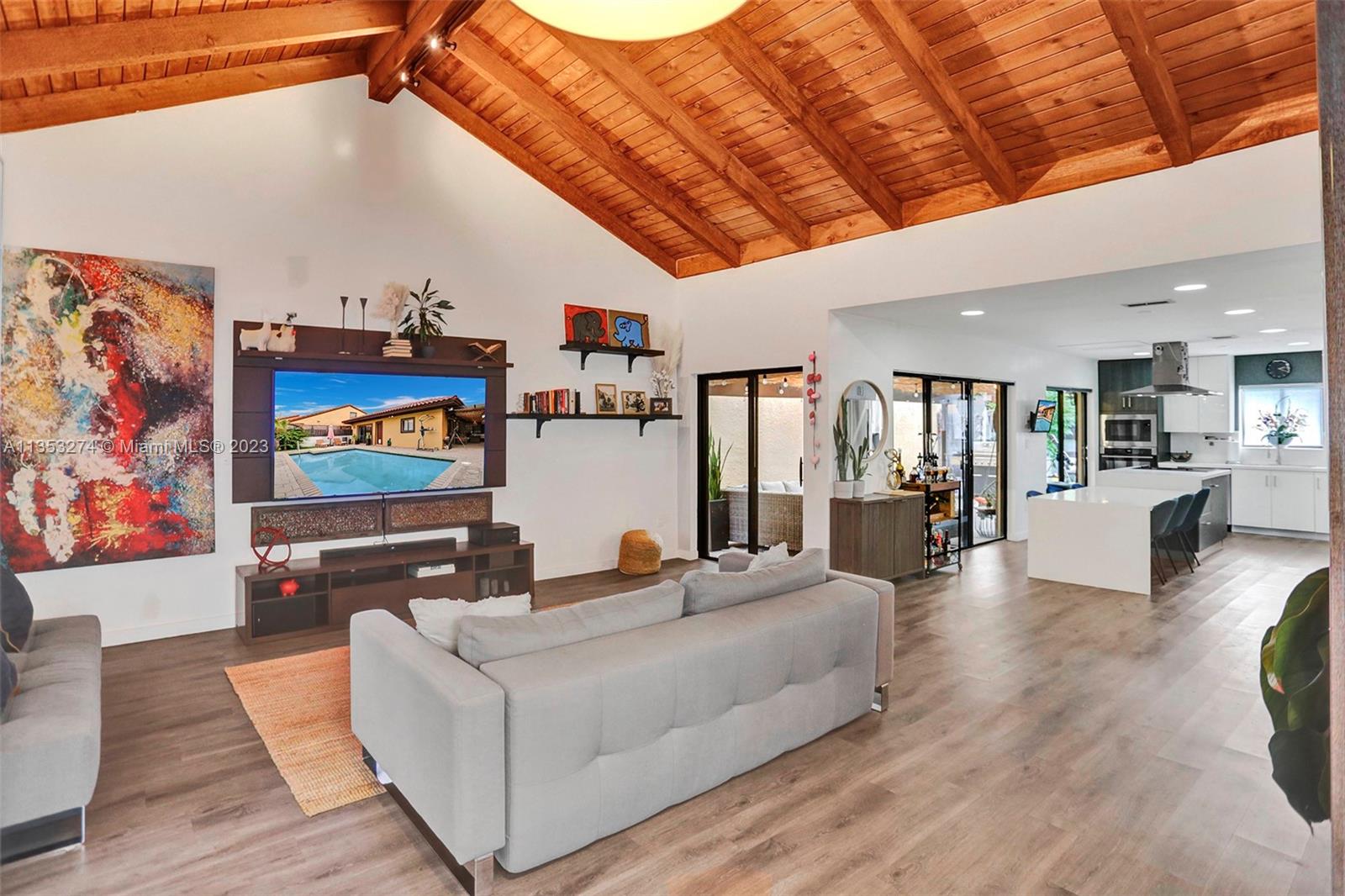 1037 Northeast 202nd Lane Miami, FL 33179 - Photo 2 of 21 a living room with furniture and a flat screen tv