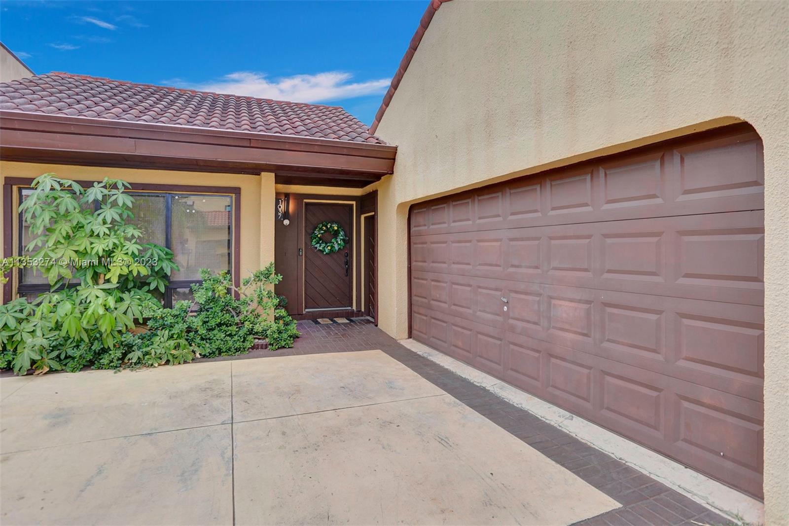 1037 Northeast 202nd Lane Miami, FL 33179 - Photo 21 of 21 a view of front door with yellow lighting
