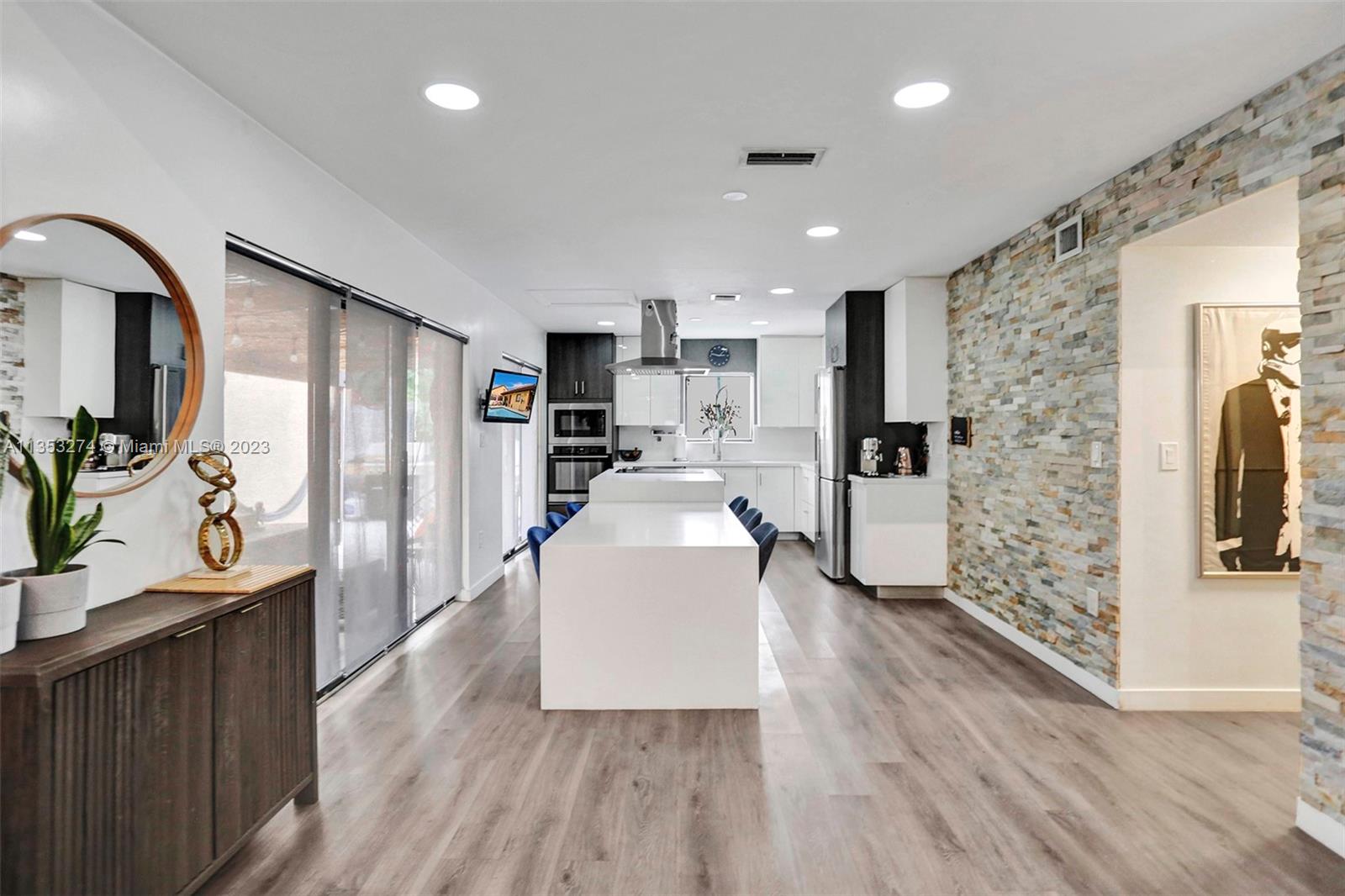 1037 Northeast 202nd Lane Miami, FL 33179 - Photo 6 of 21 a kitchen with refrigerator and window