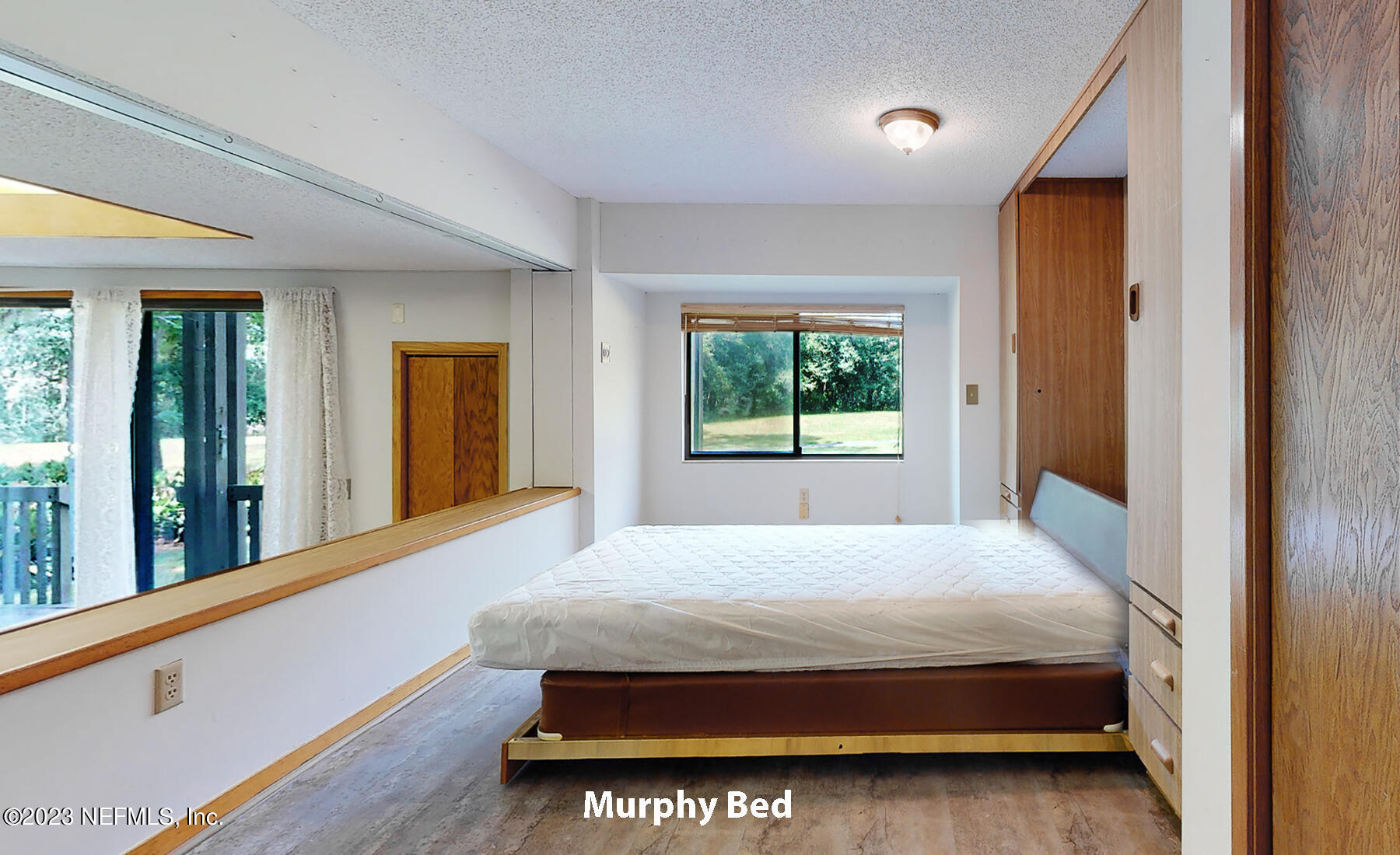 2910 Ravines Road, Unit 1102 Middleburg, FL 32068 - Photo 20 of 43 a bed sitting in a bedroom next to a window