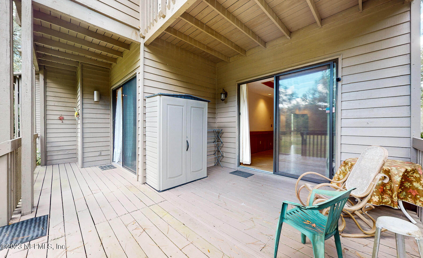 2910 Ravines Road, Unit 1102 Middleburg, FL 32068 - Photo 21 of 43 a view of a patio with table and chairs and wooden floor