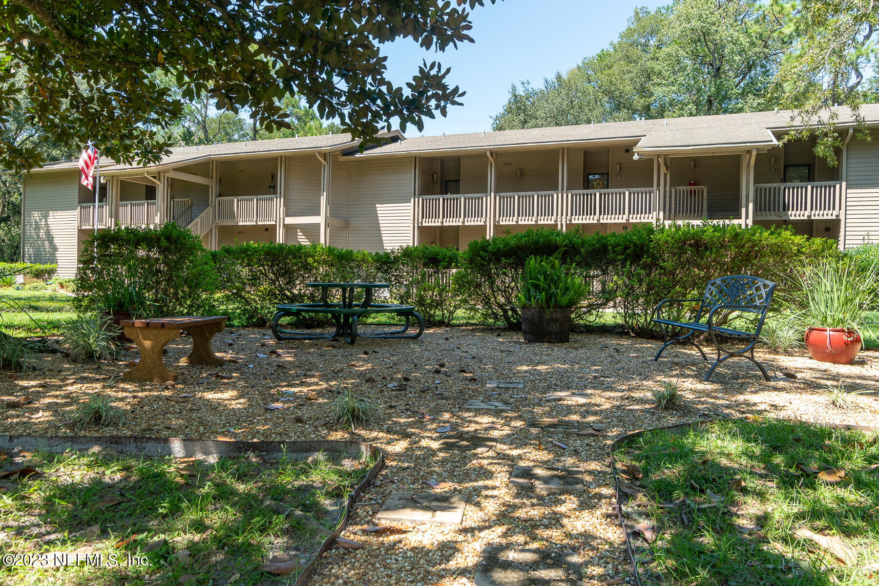 2910 Ravines Road, Unit 1102 Middleburg, FL 32068 - Photo 28 of 43 a front view of a house with a yard and potted plants