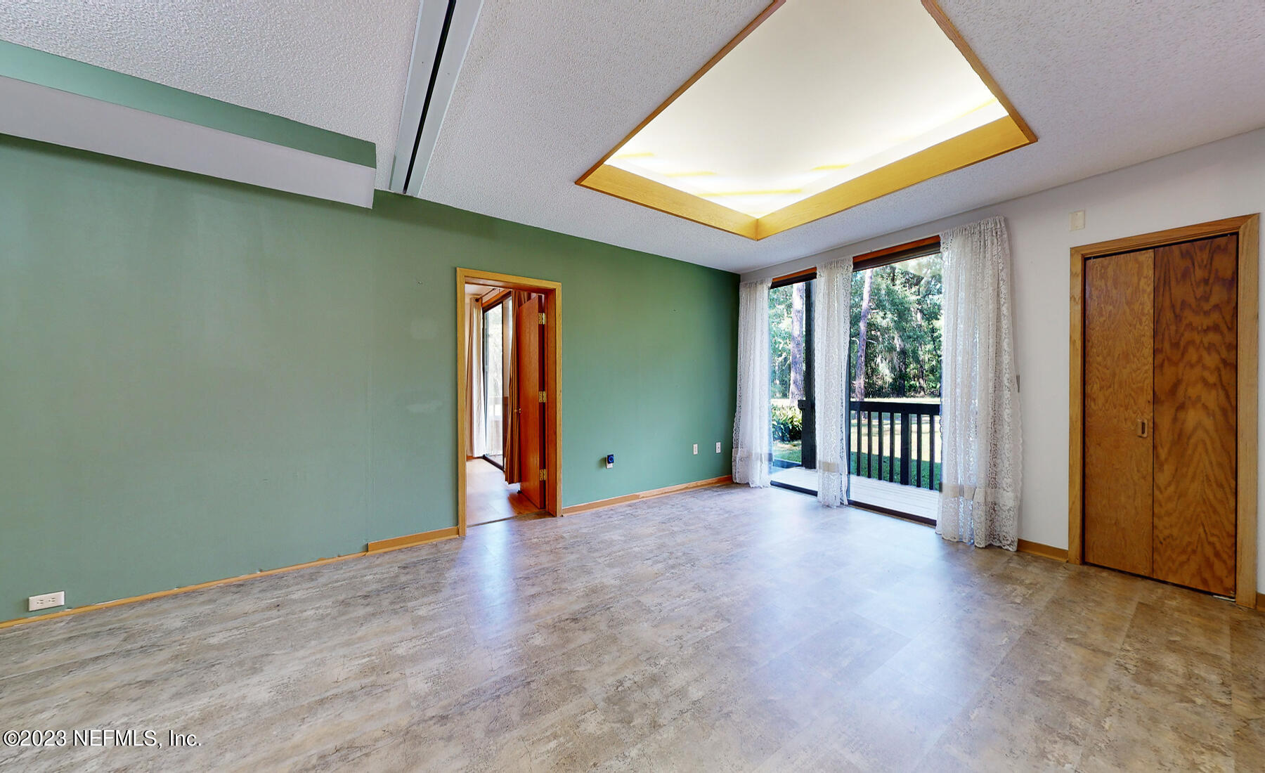 2910 Ravines Road, Unit 1102 Middleburg, FL 32068 - Photo 4 of 43 an empty room with wooden floor and windows