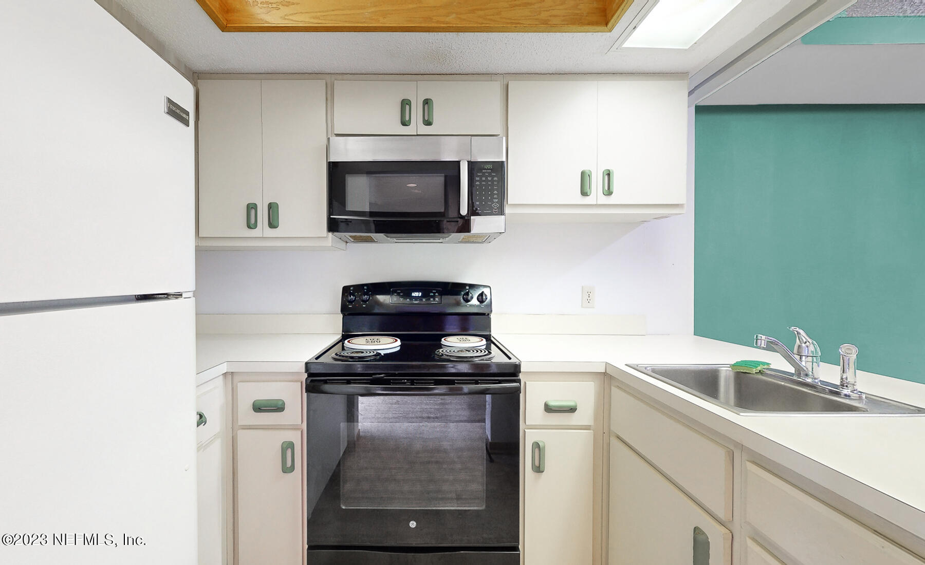 2910 Ravines Road, Unit 1102 Middleburg, FL 32068 - Photo 8 of 43 a kitchen with a sink and a stove top oven