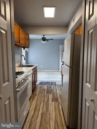 a kitchen with kitchen island granite countertop a stove a sink and a microwave