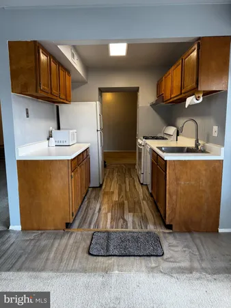 a kitchen with a sink a stove and cabinets