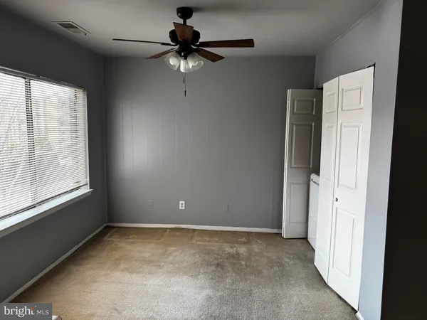 a view of a kitchen cabinets and refrigerator