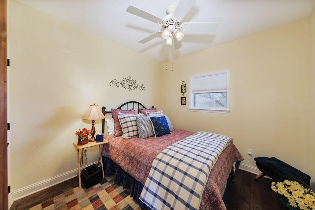 4460 Hildreth Pool Road Bowie, TX 76230 - Photo 21 of 40 a bedroom with a bed and a chandelier