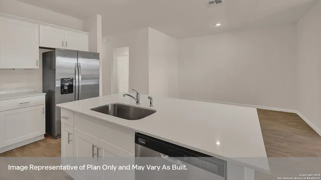 a kitchen with a sink and a refrigerator