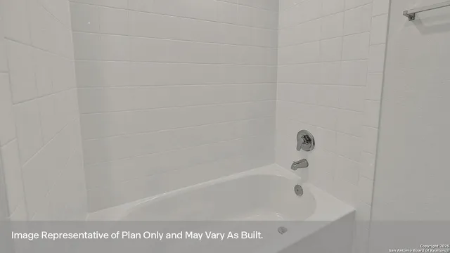 a bath tub sitting next to a white sink and a shower