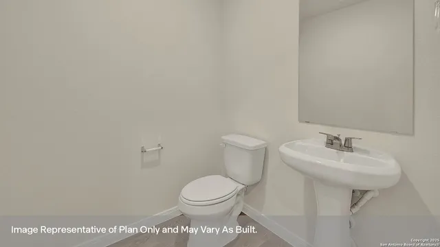 a bathroom with a toilet a sink and mirror