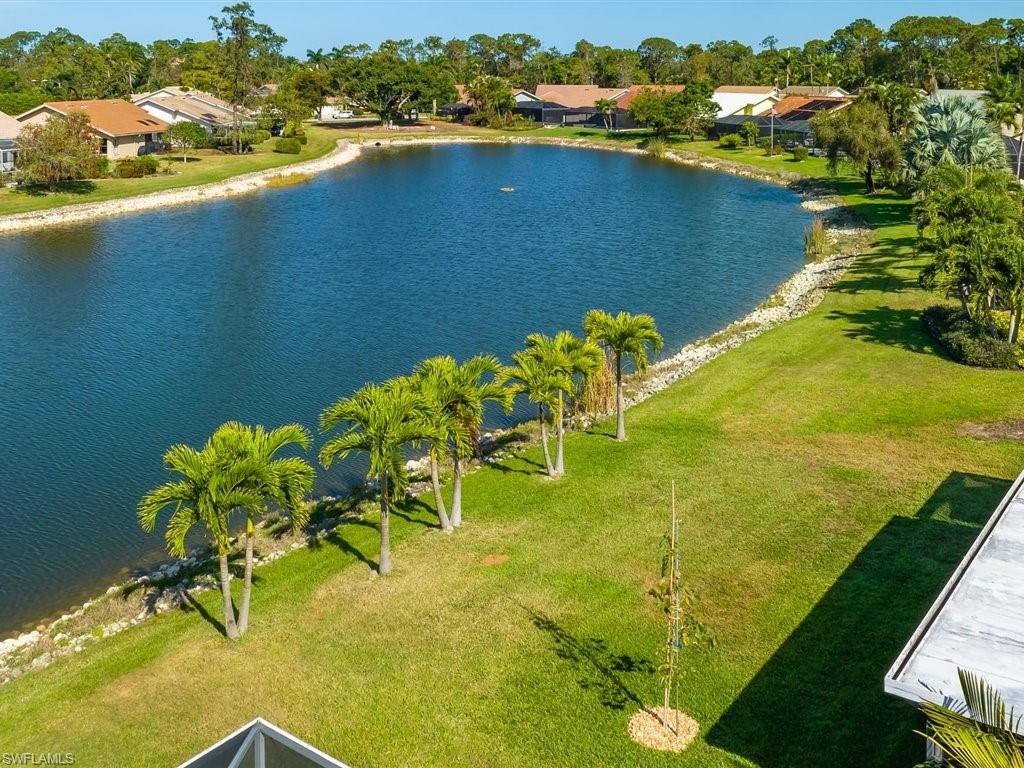 360 Fox Den Circle Naples, FL 34104 - Photo 1 of 41 a view of a lake with a yard