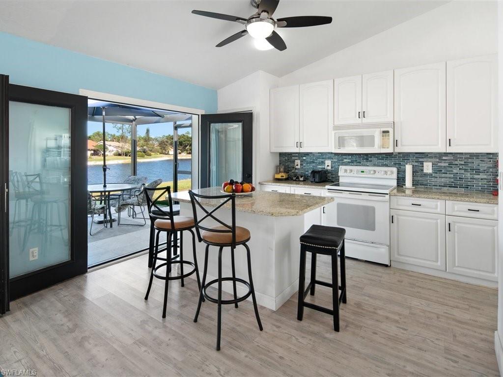 360 Fox Den Circle Naples, FL 34104 - Photo 11 of 41 a view of a dining room with furniture and wooden floor