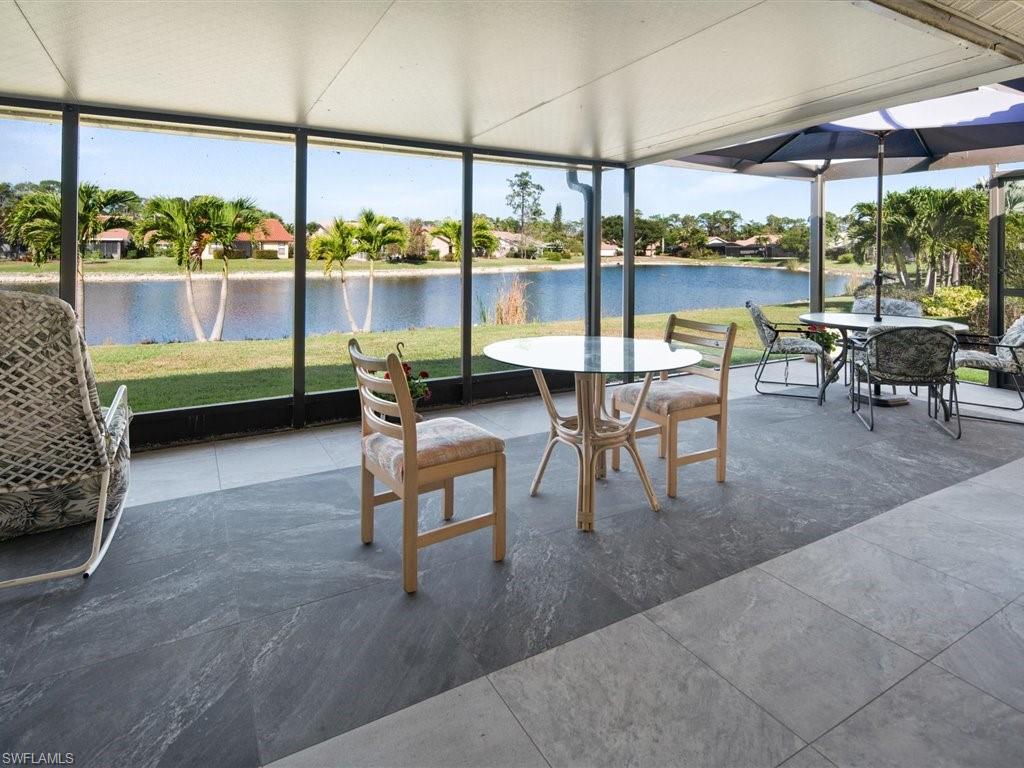 360 Fox Den Circle Naples, FL 34104 - Photo 16 of 41 a dining room with furniture and a floor to ceiling window