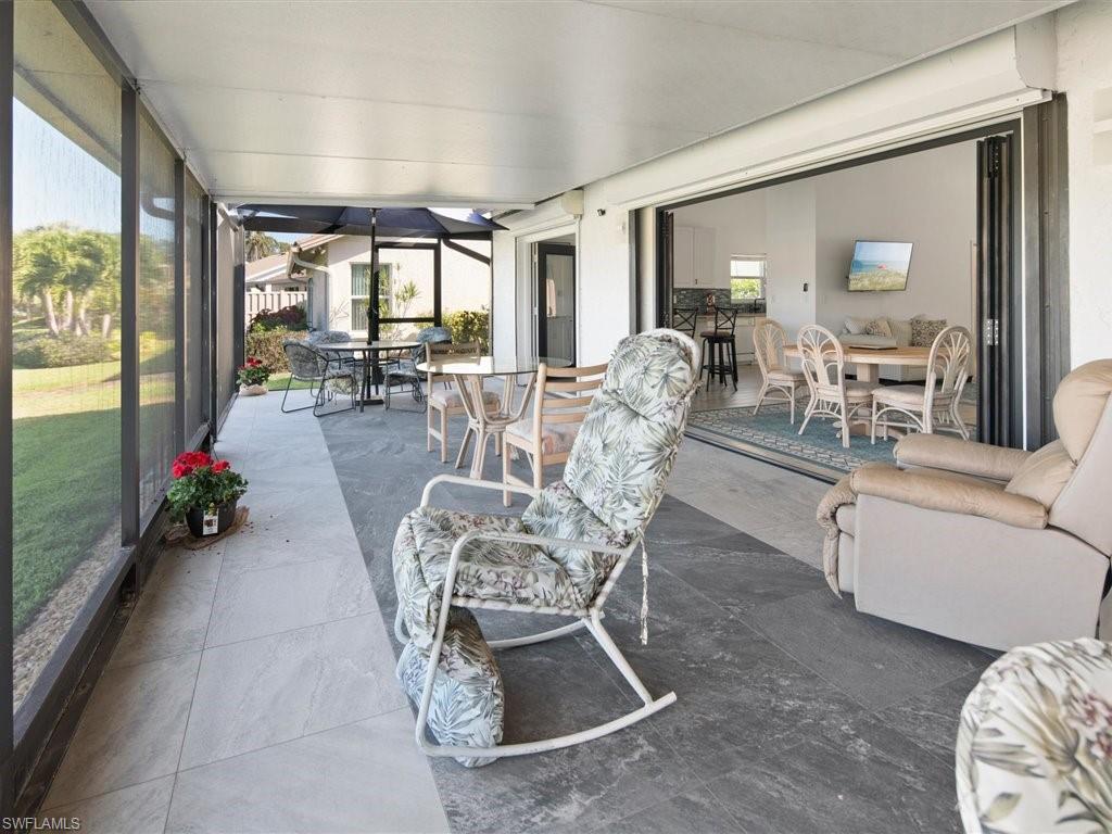 360 Fox Den Circle Naples, FL 34104 - Photo 17 of 41 a living room with furniture and a large window