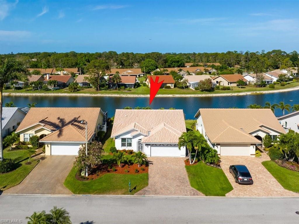 360 Fox Den Circle Naples, FL 34104 - Photo 2 of 41 an aerial view of a house with a lake view