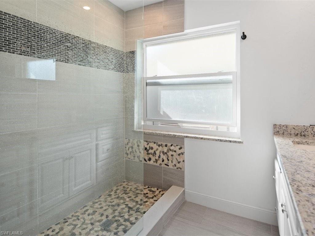 360 Fox Den Circle Naples, FL 34104 - Photo 20 of 41 a bathroom with a window