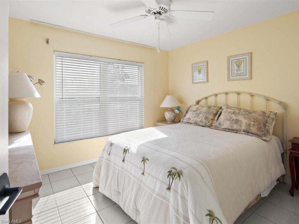 360 Fox Den Circle Naples, FL 34104 - Photo 24 of 41 a bedroom with a bed and a window