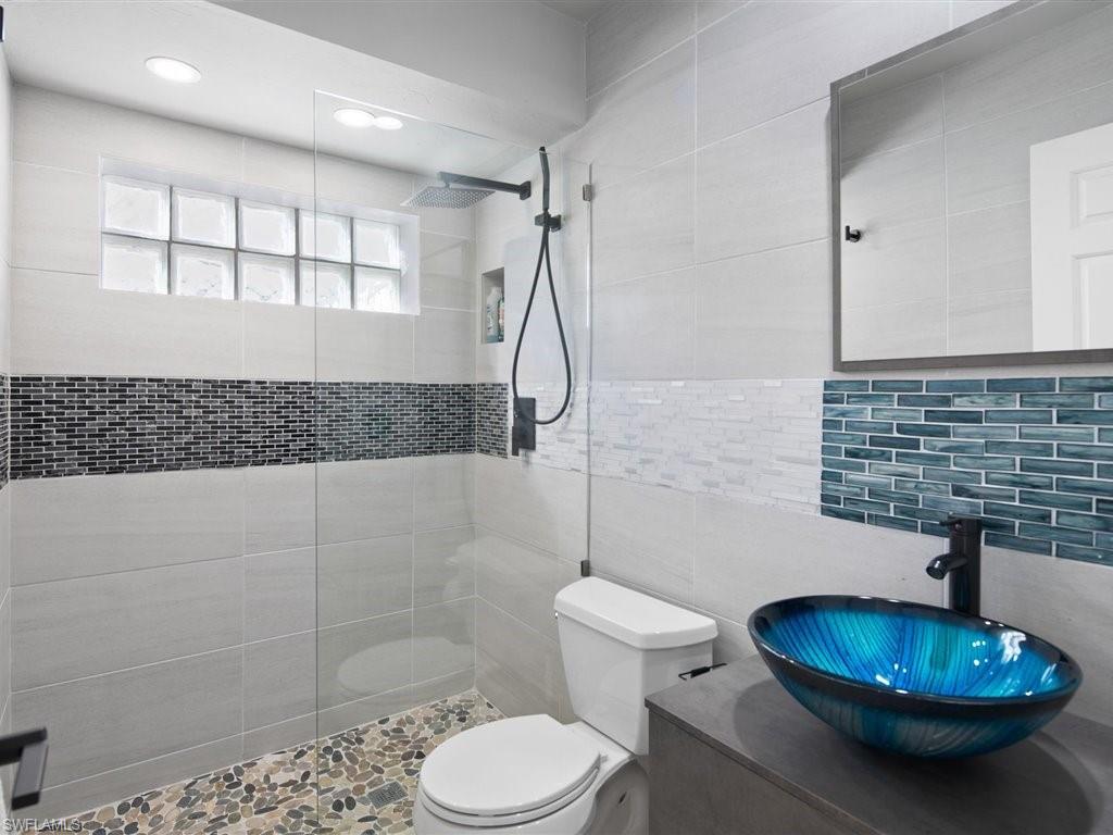 360 Fox Den Circle Naples, FL 34104 - Photo 26 of 41 a bathroom with a sink toilet and shower