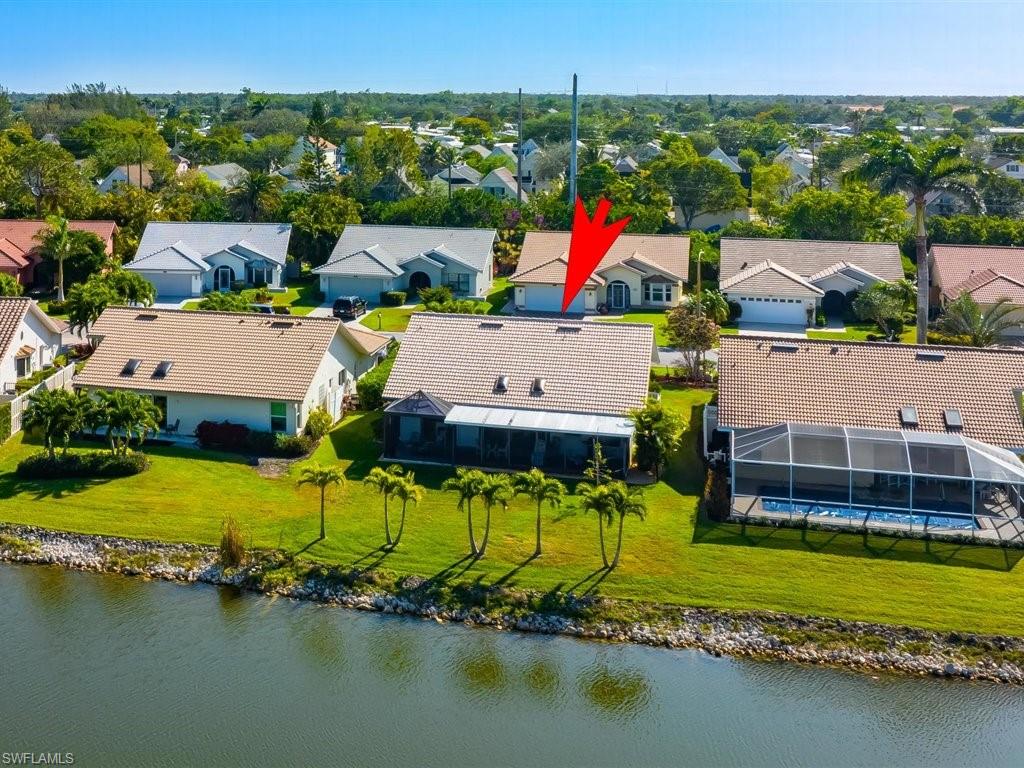 360 Fox Den Circle Naples, FL 34104 - Photo 27 of 41 an aerial view of a house with a swimming pool patio and outdoor seating