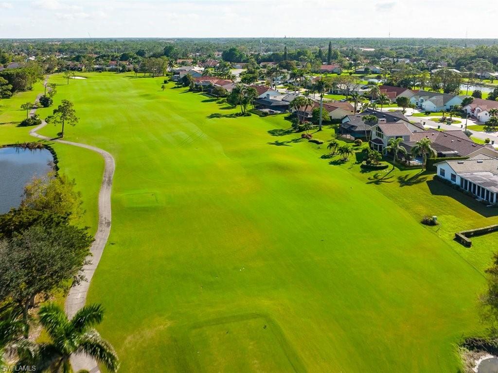 360 Fox Den Circle Naples, FL 34104 - Photo 28 of 41 a view of a lake with a houses
