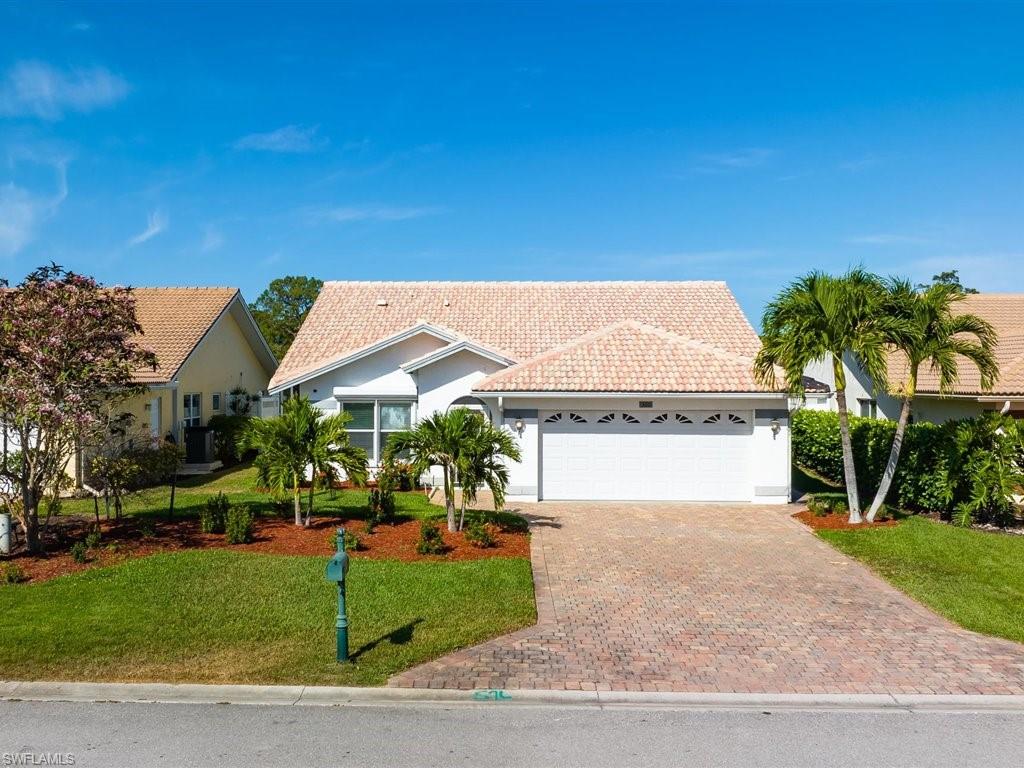 360 Fox Den Circle Naples, FL 34104 - Photo 3 of 41 a view of house with outdoor space and sitting area