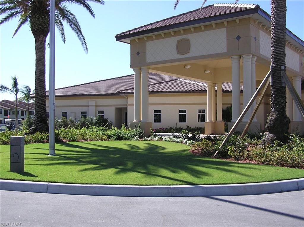 360 Fox Den Circle Naples, FL 34104 - Photo 31 of 41 a front view of a house with a yard table and chairs