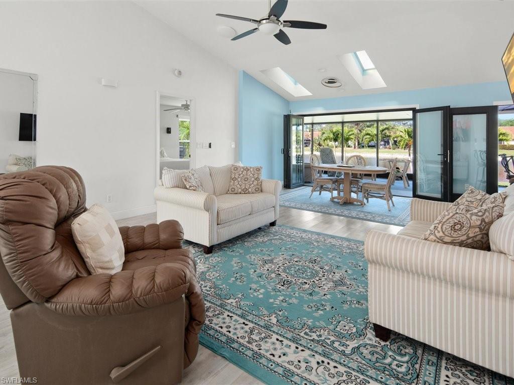 360 Fox Den Circle Naples, FL 34104 - Photo 7 of 41 a living room with furniture and a large window