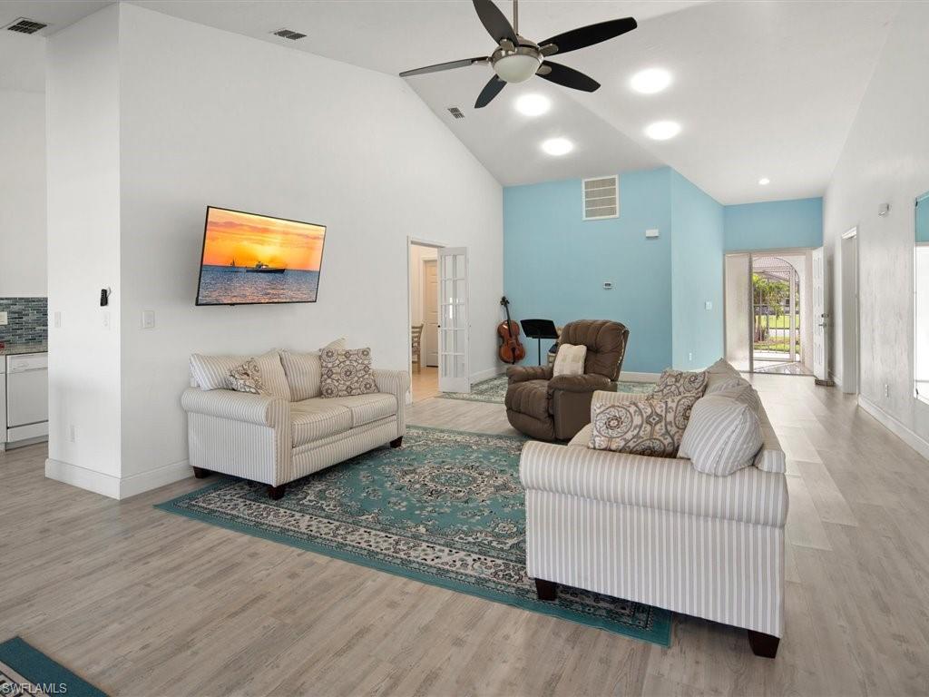 360 Fox Den Circle Naples, FL 34104 - Photo 8 of 41 a living room with furniture and a flat screen tv