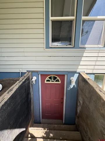 a living room with furniture and a lamp