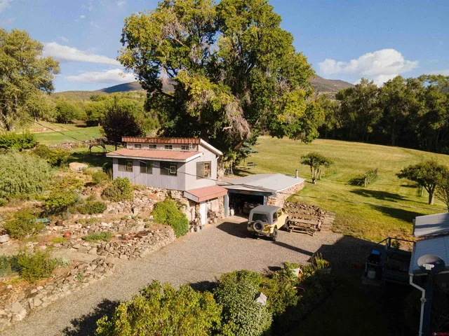 a view of a swimming pool with lawn chairs under an umbrella