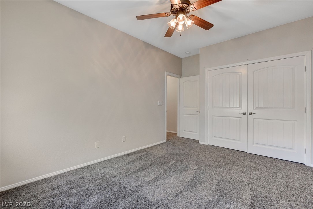 191 Verde Ridge Court Henderson, NV 89012 - Photo 29 of 36 Unfurnished bedroom featuring carpet flooring, baseboards, a closet, and ceiling fan