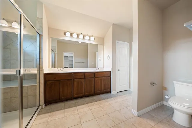 a spacious bathroom with a granite countertop sink mirror and toilet
