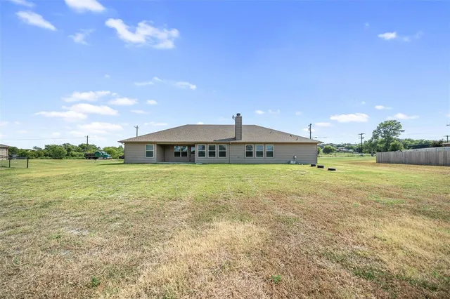 a front view of house with yard and garage