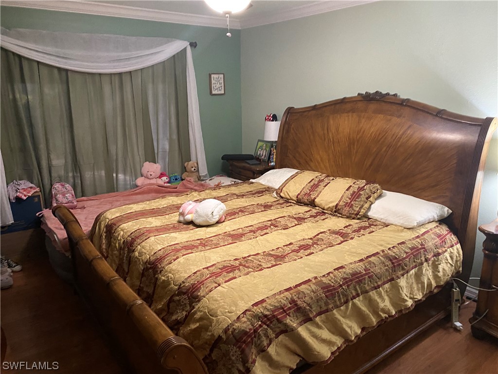 5968 Bay Point Road Bokeelia, FL 33922 - Photo 5 of 11 a bedroom with a bed and a table