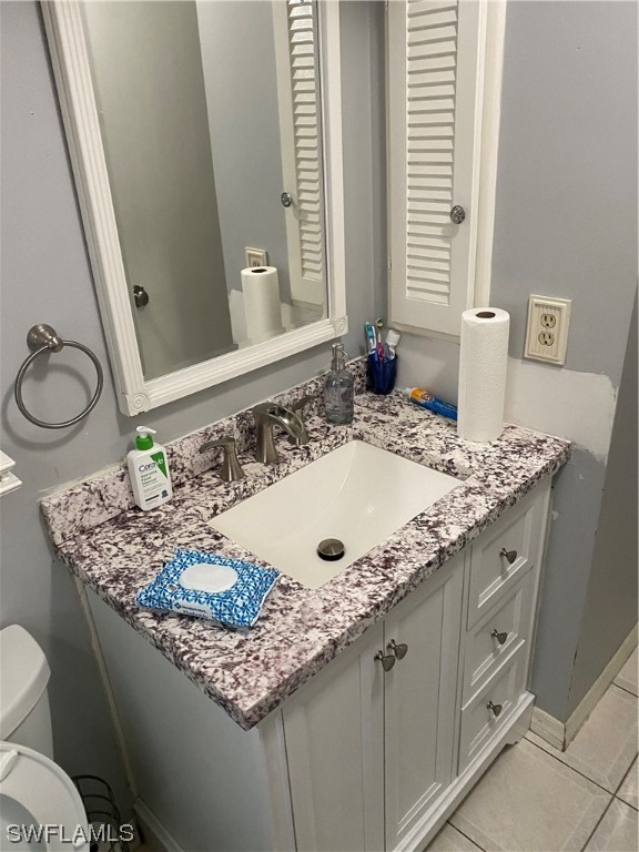 5968 Bay Point Road Bokeelia, FL 33922 - Photo 7 of 11 a bathroom with a granite countertop sink and a mirror