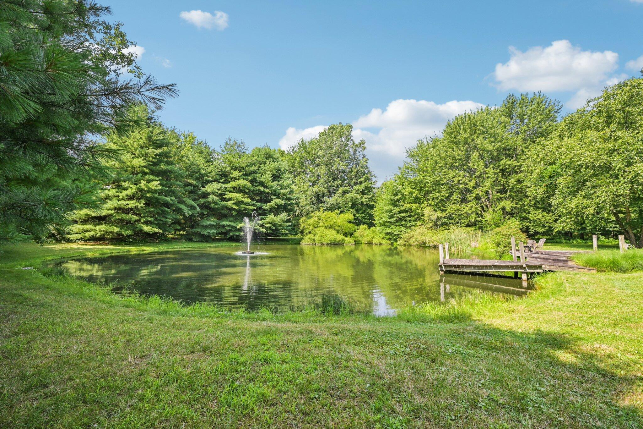 7700 Plumb Road Galena, OH 43021 - Photo 20 of 94 A tranquil pond view framed by mature trees and highlighted by a central fountain and charming dock for quiet enjoyment or entertaining.