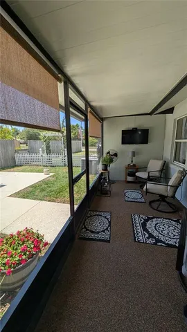 a living room with furniture and a floor to ceiling window