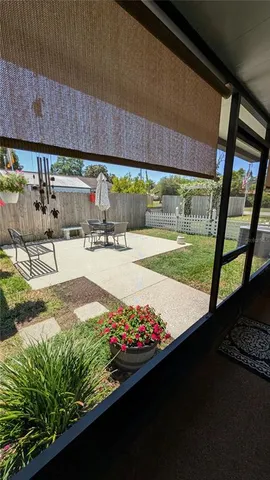 a view of a patio with wooden fence and a couple of chairs