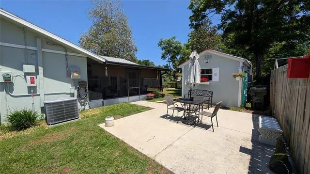 a view of a patio with a table and chairs and potted plants