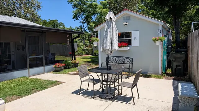 a view of a patio with table and chairs and potted plants